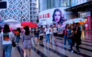 Umbrella-clad pedestrians don't let a little (or a lot) of rain get the best of their shopping experience in Dongdaemun Design Plaza in Seoul