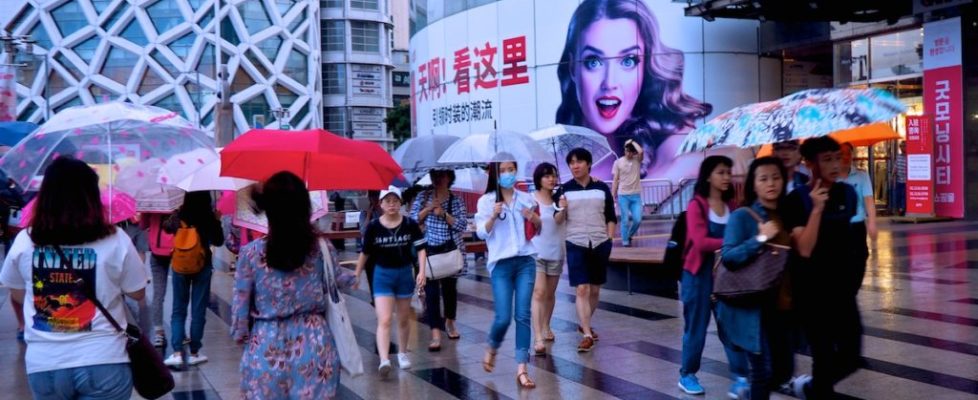 Umbrella-clad pedestrians don't let a little (or a lot) of rain get the best of their shopping experience in Dongdaemun Design Plaza in Seoul